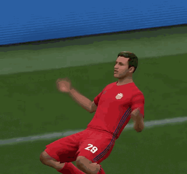 a soccer player with the number 29 on his shorts is kneeling down on the field