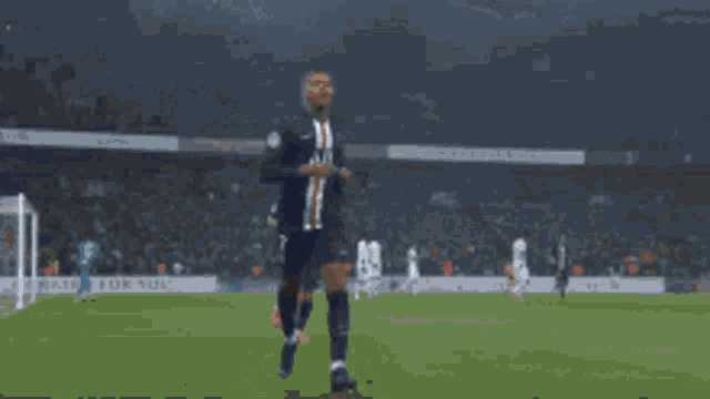 a soccer player is celebrating a goal with his teammates