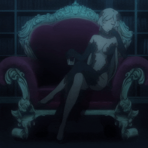 a woman in a black dress is sitting in a chair holding a glass of wine