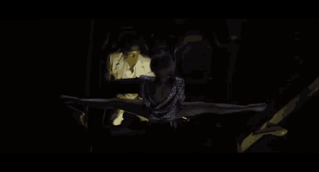 a woman is doing a split while a man looks on .