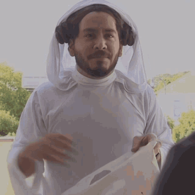 a man with a beard is dressed as a princess leia