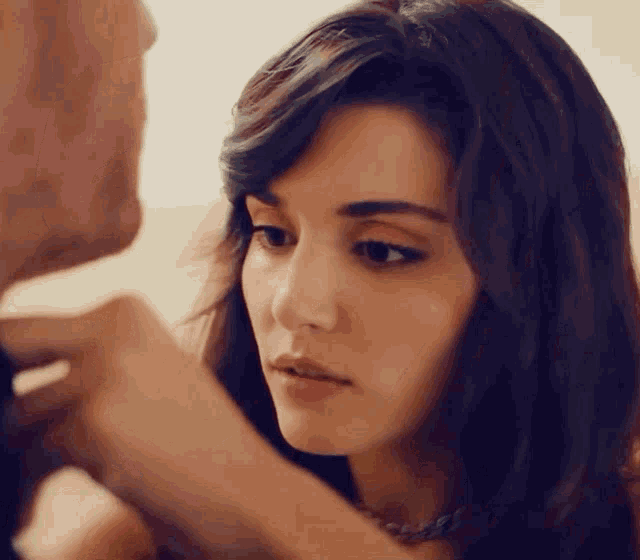 a close up of a woman looking at a man 's neck