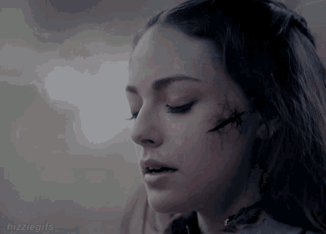 a close up of a woman 's face with the hashtag hizziegifs below her