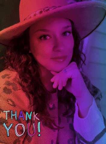 a woman wearing a hat and a sweater with tha written on her sweater