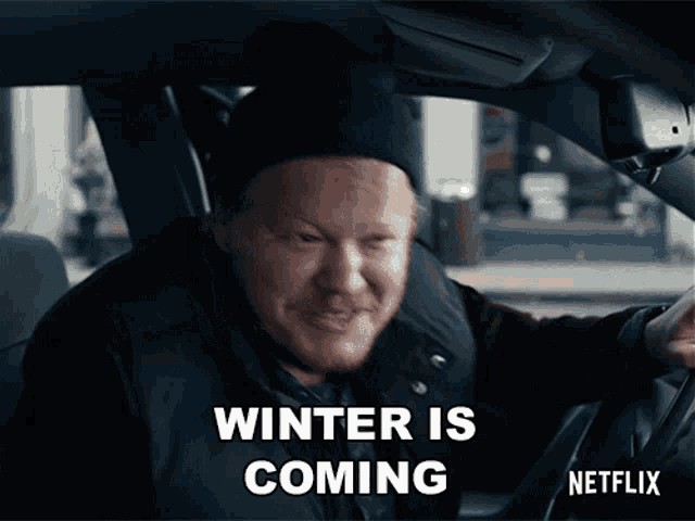 a man in a car with the words winter is coming on his face