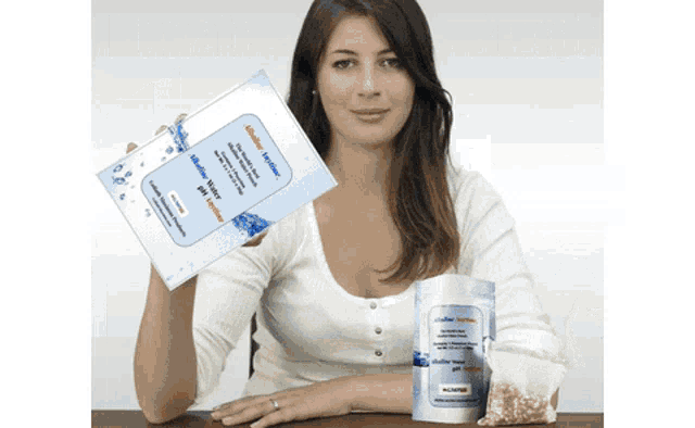 a woman holding a pamphlet and a bag of wipes