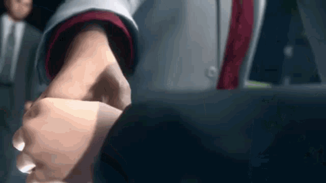 a close up of two people shaking hands in a video game .