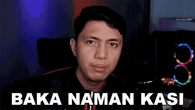 a man is sitting in front of a computer with the words baka naman kasi on the screen