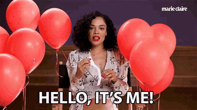 a woman says hello it 's me in front of balloons