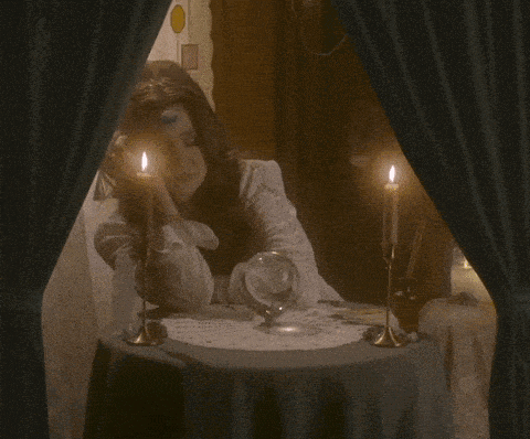 a woman sitting at a table with the words " you 're tired " written on it