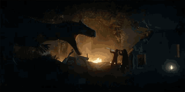 a group of people are standing in front of a house that has been destroyed by a dinosaur at night