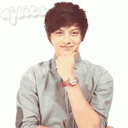 a young man wearing a grey shirt and a red watch is smiling
