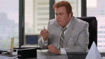 a man in a suit and tie sitting at a desk