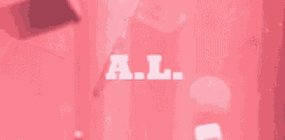 a person is holding a bloody knife on a pink background .