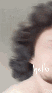 a close up of a woman 's face with the word hello written on her face