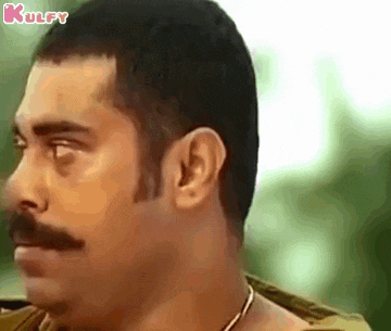 a close up of a man 's face with a mustache looking to the side .