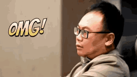 a man with glasses and the word omg in the background