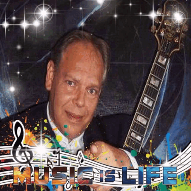a man holding a guitar in front of a sign that says " music is life "