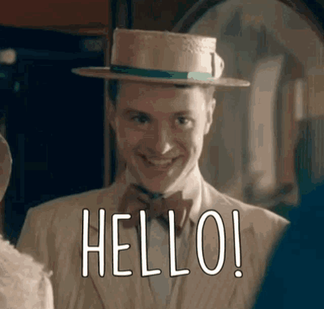 a man wearing a straw hat and bow tie is smiling and saying hello .