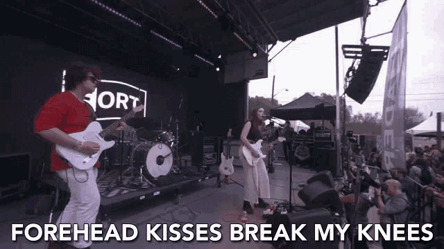 a man playing a guitar and a woman singing on a stage with the words forehead kisses break my knees