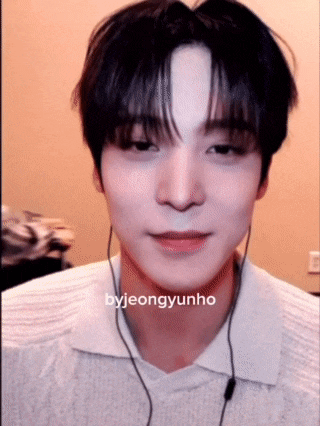 a young man wearing headphones and a white shirt with the name byjeongyunho on it .