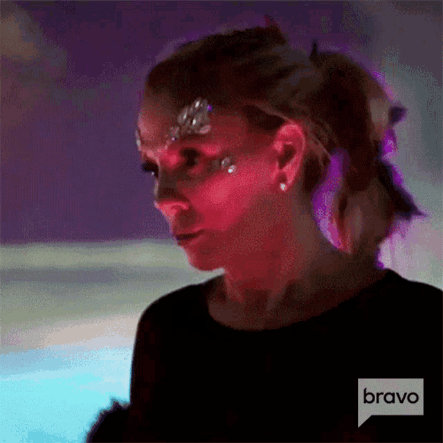 a woman with a ponytail and rhinestones on her face is on bravo .