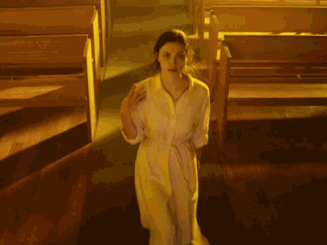 a woman in a church with her hands folded praying