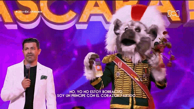 a man in a white jacket stands next to a koala mascot holding a bottle