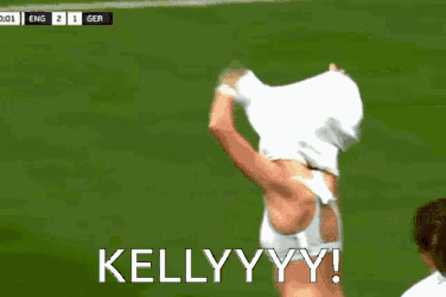 a woman in a white top and white shorts is on a soccer field with kellyyyy written on the bottom