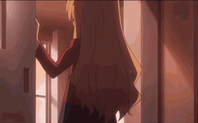 a girl in a red jacket is standing in a doorway