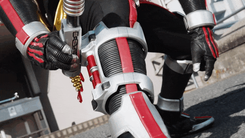 a close up of a person wearing a superhero costume with a red and silver stripe