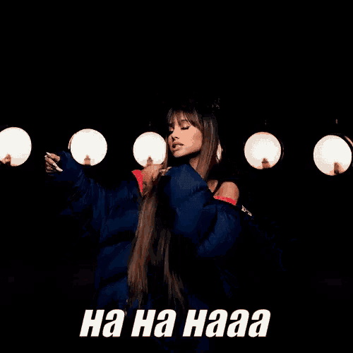 ariana grande is wearing a blue jacket and a black tank top