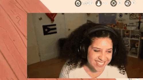 a woman wearing headphones is smiling in front of a wooden wall