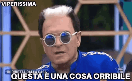 a man wearing sunglasses and a blue shirt says " viperissima "