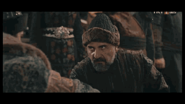 a screenshot of a tv show shows two men shaking hands