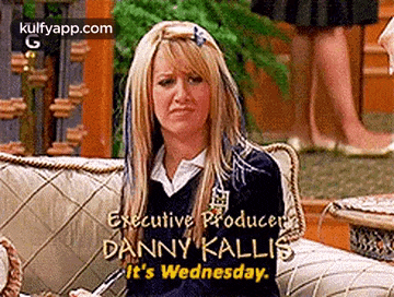 a woman is sitting on a couch with the words `` executive producer danny kallis it 's wednesday . ''