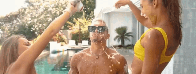 a man in a yellow bikini is being sprayed with champagne