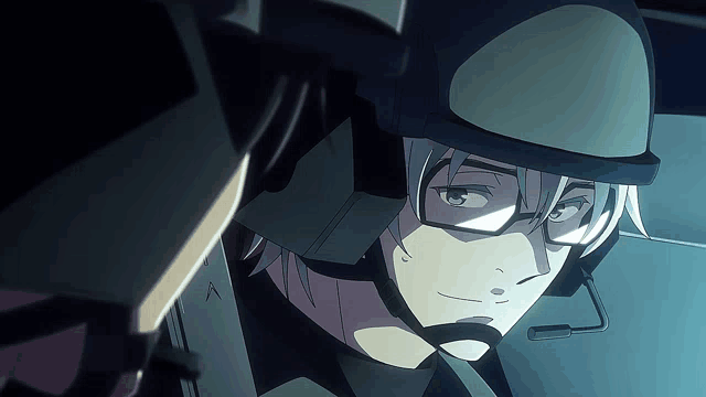 a man wearing a helmet and glasses is looking at another man