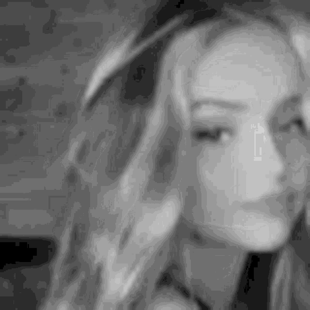 a black and white photo of a woman 's face .