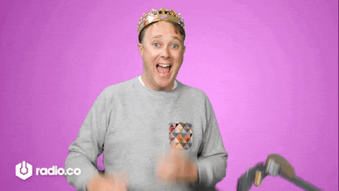 a man wearing a crown is standing in front of a microphone with radio.co written on the bottom