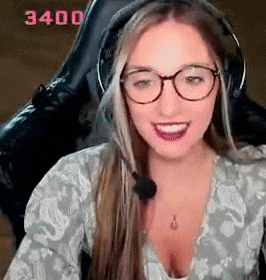a woman wearing glasses and headphones is sitting in a chair with a microphone .