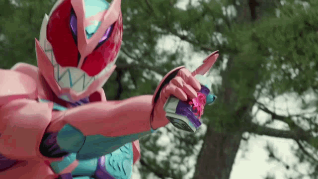 a person in a pink and purple superhero costume is holding a knife in front of a tree .