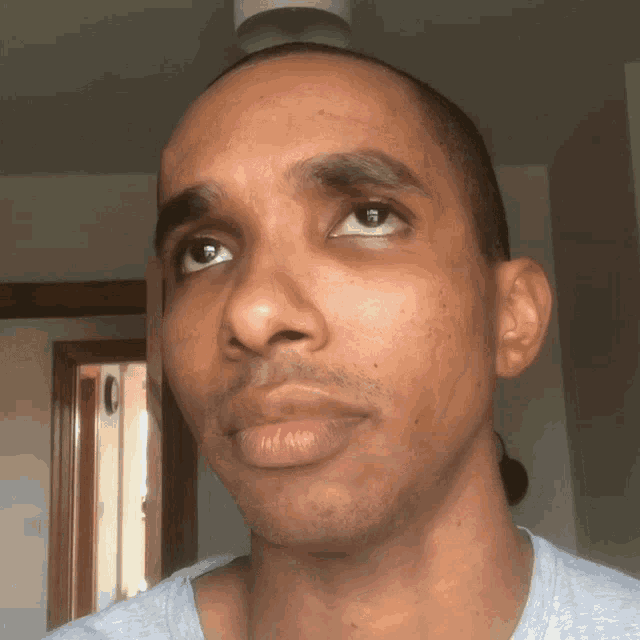 a close up of a man 's face in a room