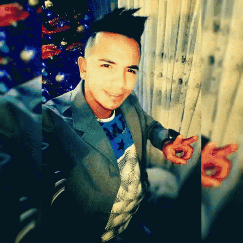 a man wearing a jacket and a shirt with a butterfly on it poses for a picture