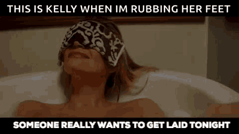 a woman wearing a blindfold is laying in a bathtub .