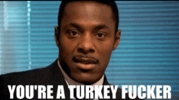 a man in a suit and tie with the words you 're a turkey fucker