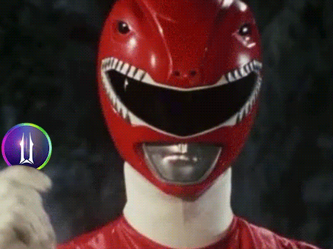a close up of a red power ranger wearing a helmet with shark teeth