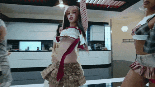 a woman in a plaid skirt is dancing in a room