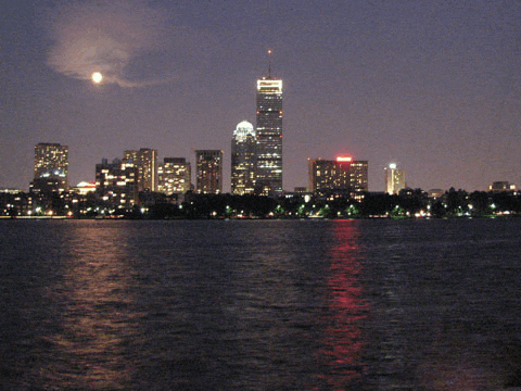 a city skyline with a full moon in the sky