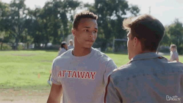a man wearing a t-shirt that says at taway on it
